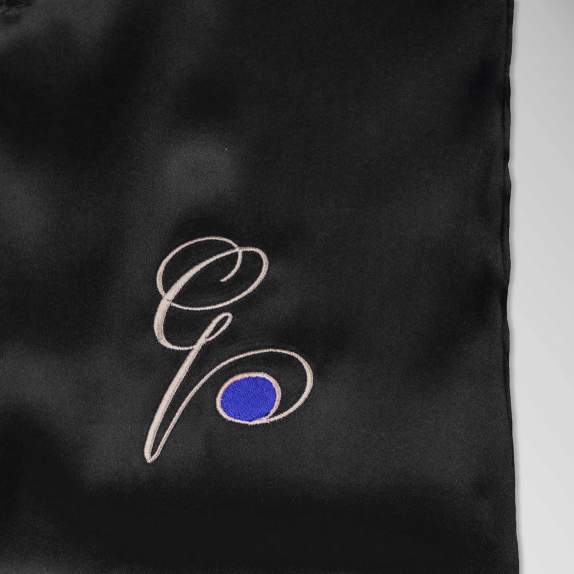 Pillowsforeplay Slip - Close up showing the high quality black slip with Elegant black cursive "G" with a blue circle